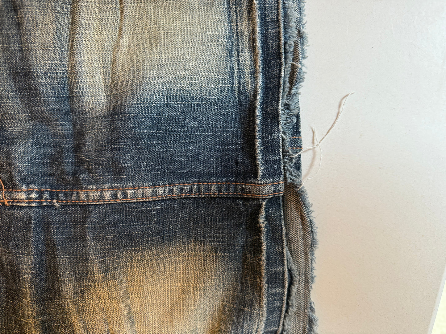 DISTRESSED DENIM MINI SKIRT